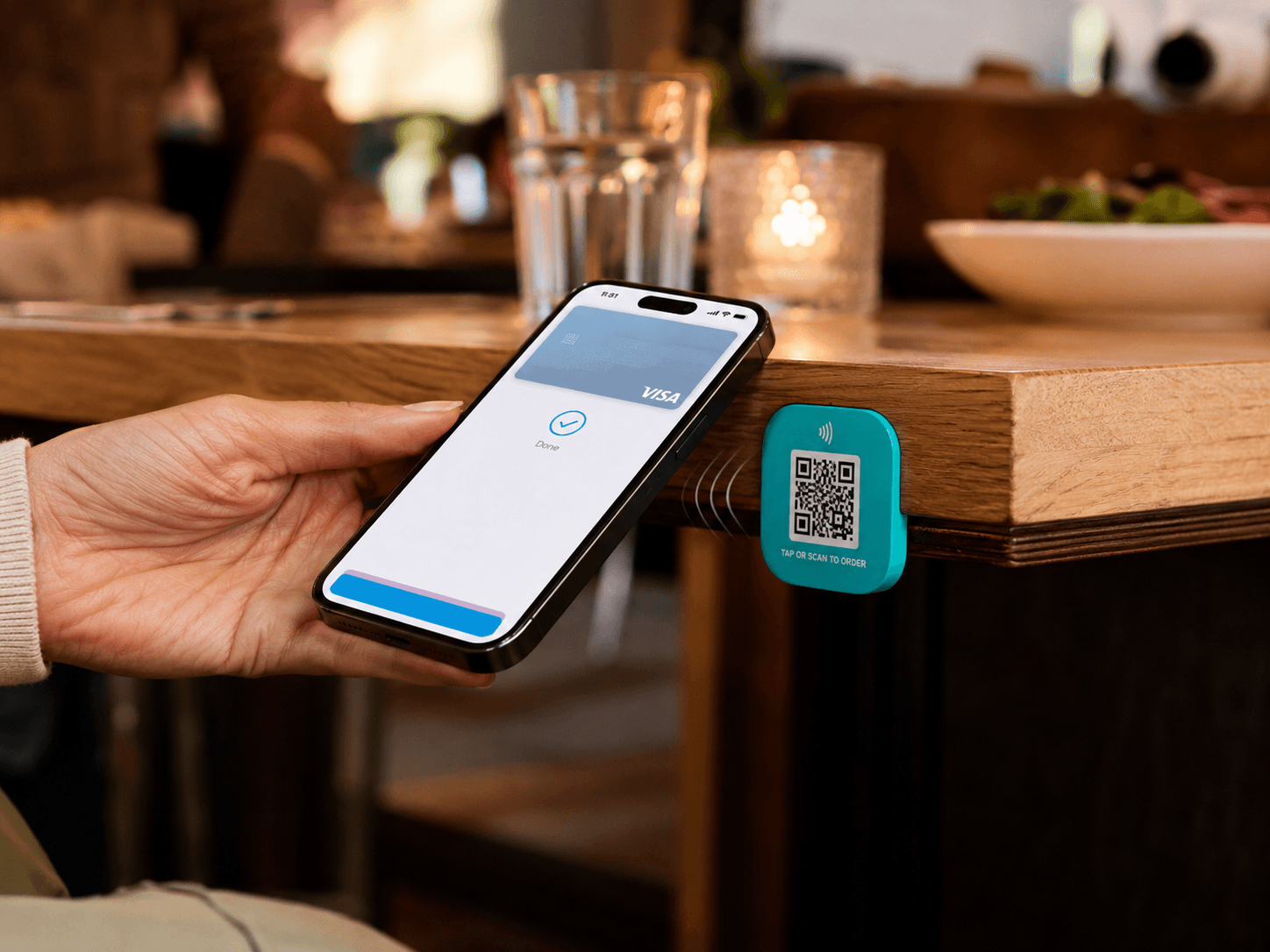 Custom teal Tapora NFC badge being tapped by a phone - printed in your brand colors