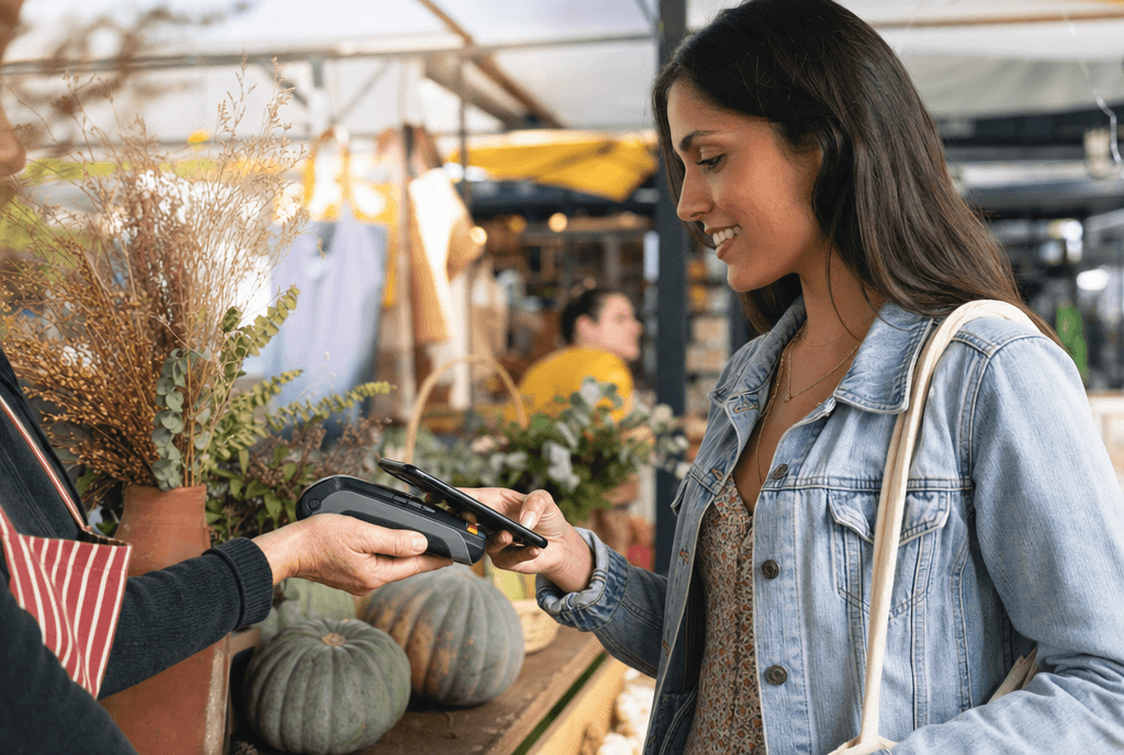 Person making a contactless payment at a market stall